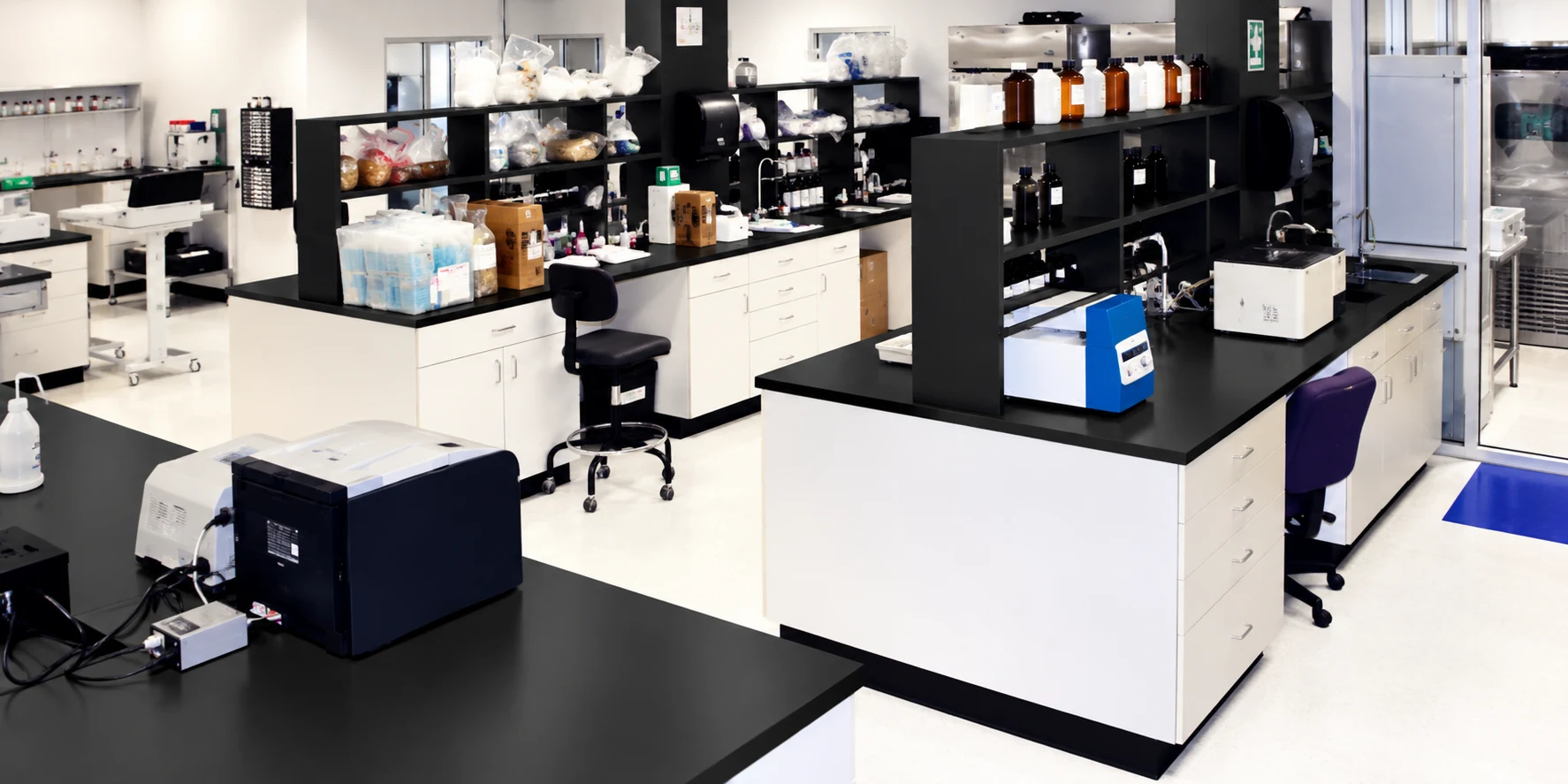 Laboratory interior with workbenches, shelving and testing equipment